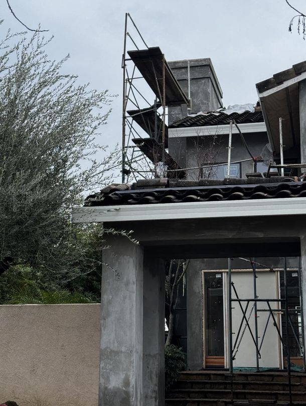 Man nail gunning window frame